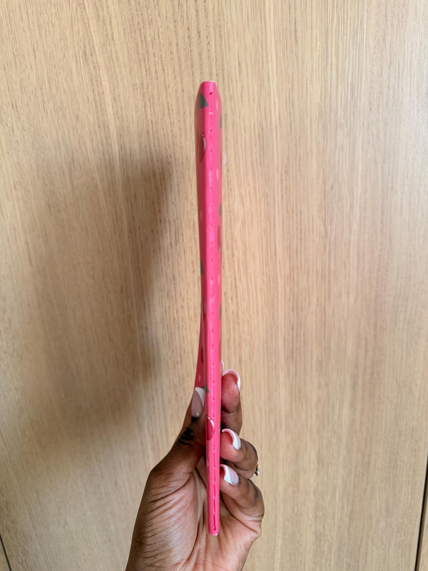 Side view of the cherry-themed notebook showing spine thickness and binding.