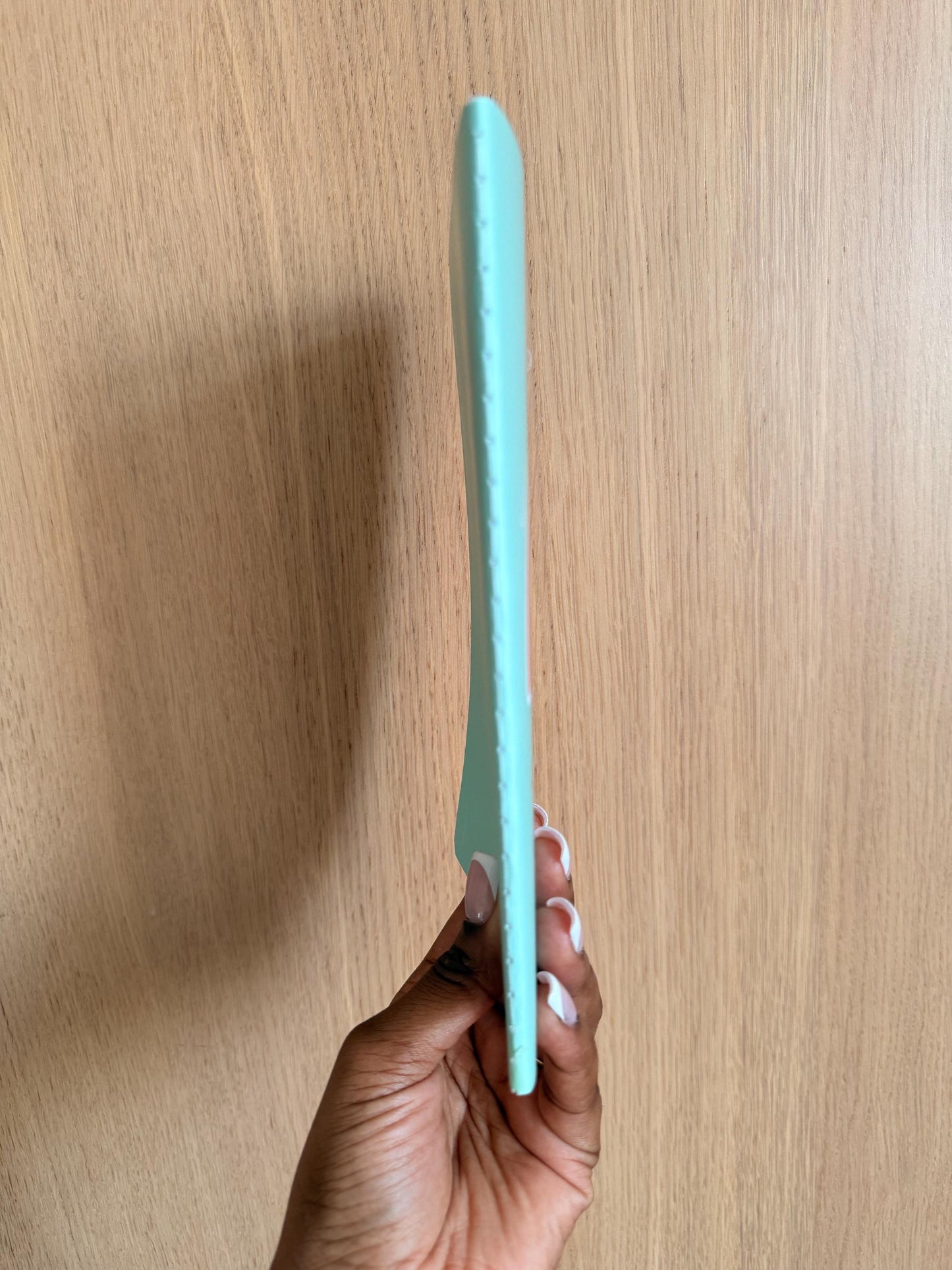 Side view of the rainbow-themed notebook showing spine thickness and binding.