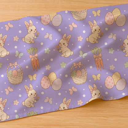 Fabric mockup showing the Easter bunny and carrot seamless pattern printed on soft white textile.