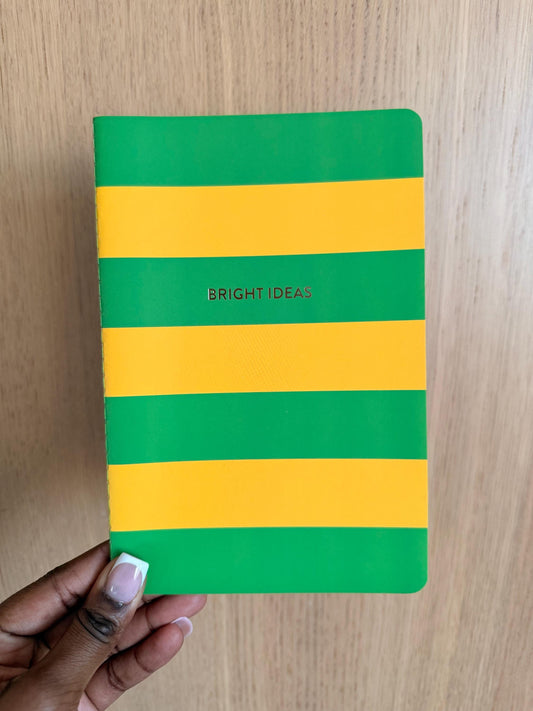 Green and yellow striped notebook with the phrase “Bright Ideas” on the cover, featuring bold horizontal color blocks.