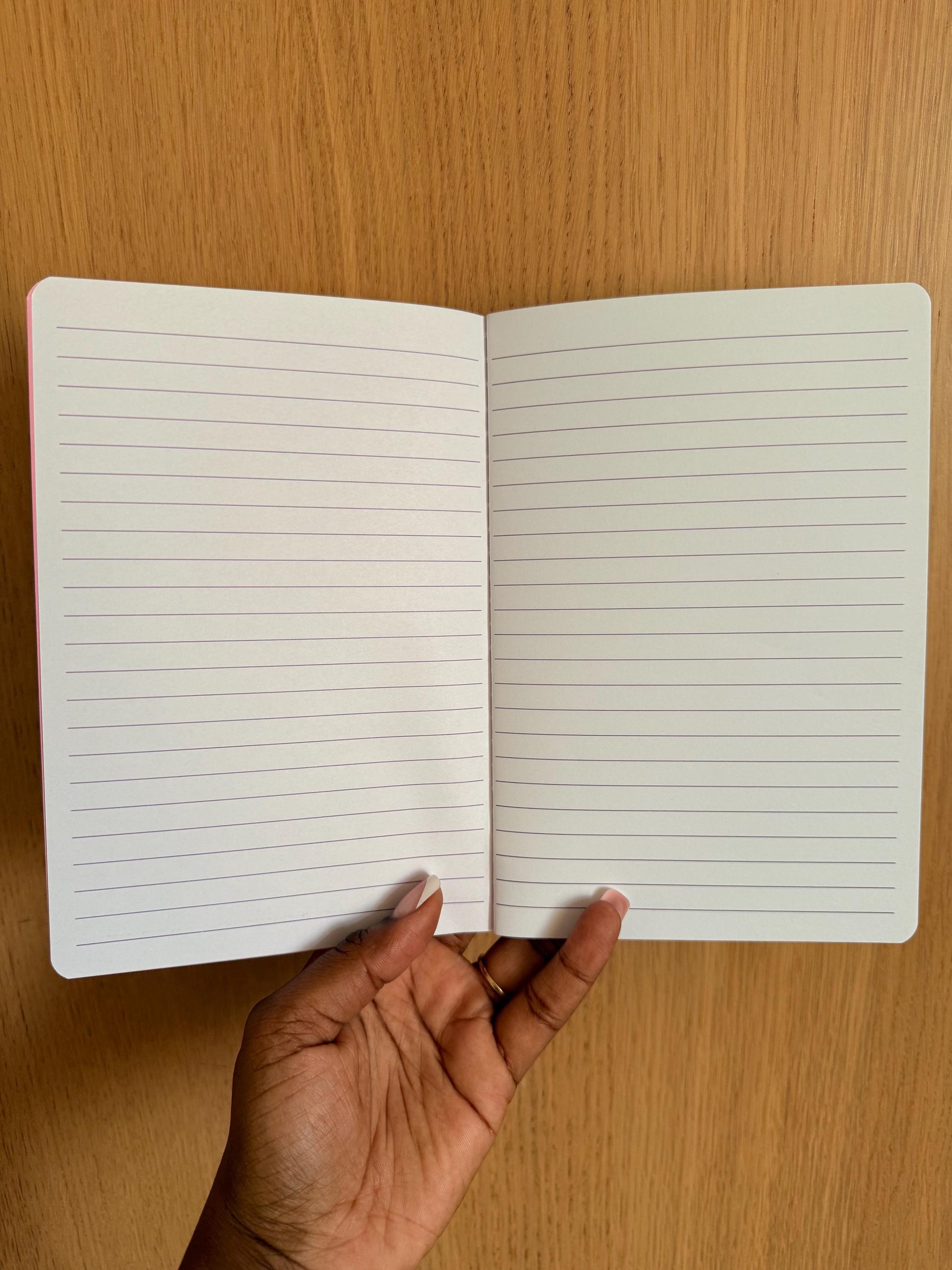 Open notebook displaying clean, lined pages suitable for journaling, school notes, or planning.