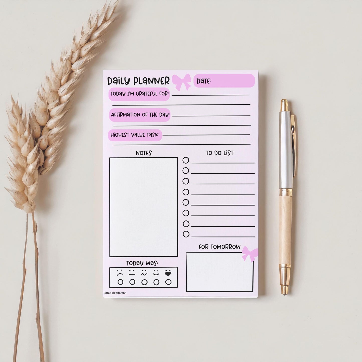 daily gratitude daily planner notepad on plain background with pen and plant