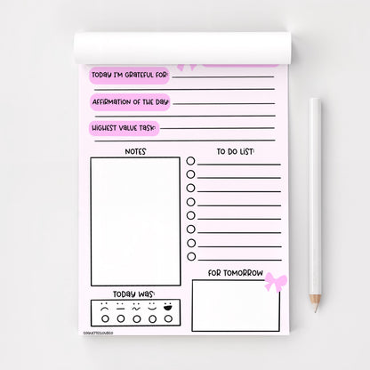 a5 daily gratitude and planner notepad on white background  with white pencil