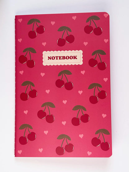 Front view of the cherry notebook showing the full cover design with red cherries and heart details on a pink background.