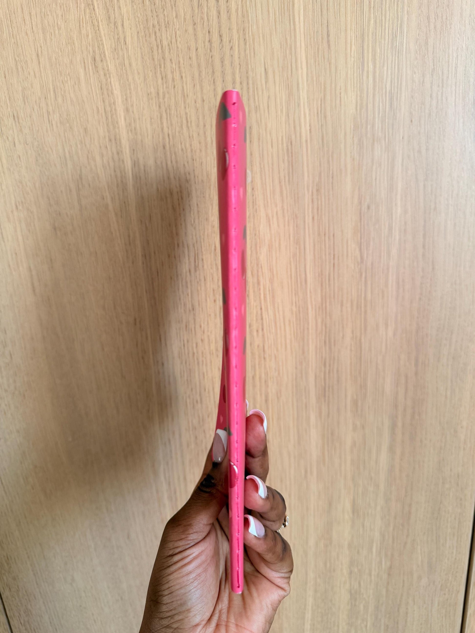 Side view of the cherry-themed notebook showing spine thickness and binding.