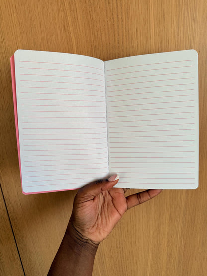 Open notebook displaying clean, evenly spaced lined pages suitable for journaling or note-taking.