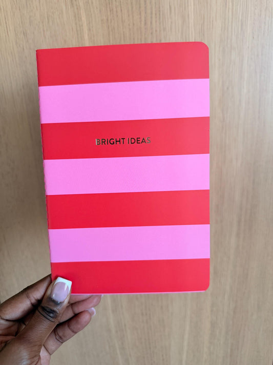 Pink and red striped notebook with bold horizontal color blocks and the phrase “Bright Ideas” centered on the cover.