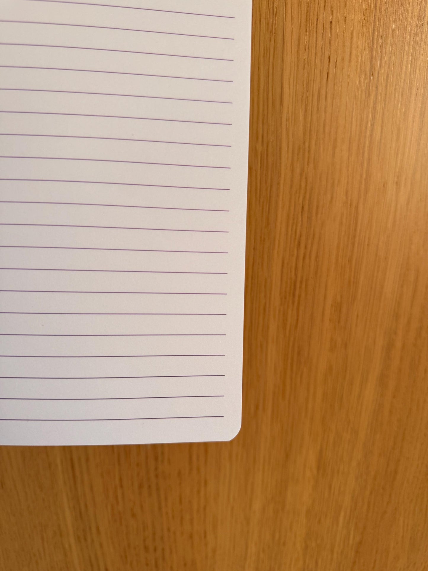 Close-up of a lined notebook page showing spacing and paper quality.
