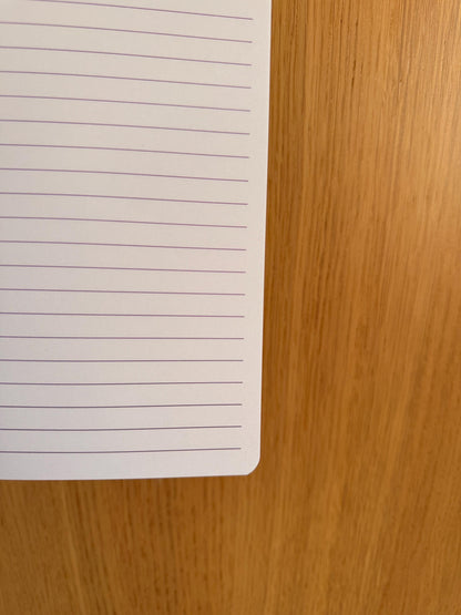 Close-up of a lined notebook page showing spacing and paper quality.