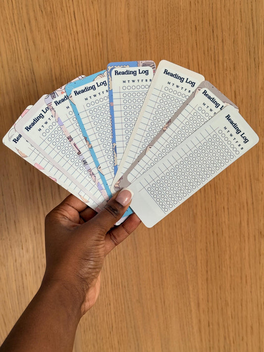 wipeable, reusable reading log trackers. size 2x6” in hand with wooden background